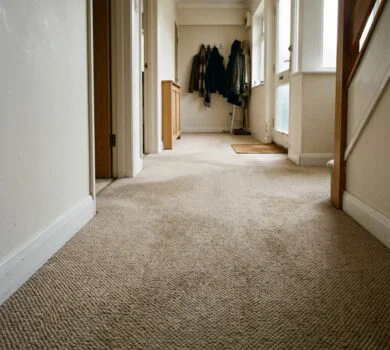 beige-coloured Axminster carpet in a London apartment hallway